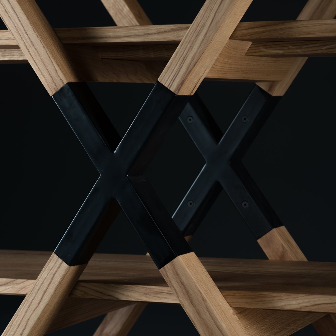 Natural oak wood with a sleek black metal accent, featuring a modern crisscross pattern. 