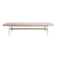 Light pink upholstered bench with a sleek metal base, ideal for modern interiors. Minimalist design and soft color.
