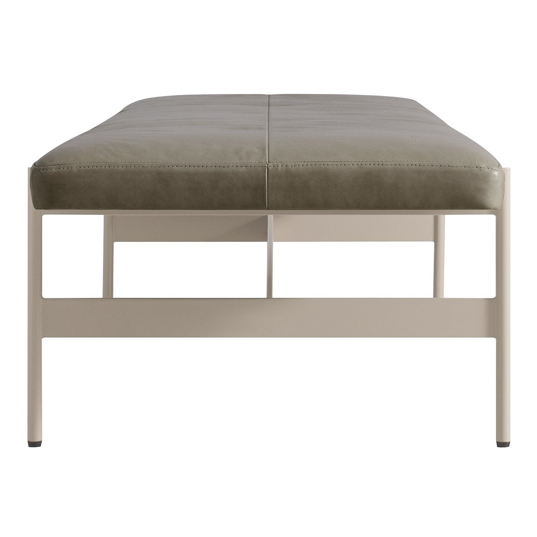 Gray upholstered ottoman with a smooth surface and a light cream metal base, minimalist design.