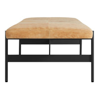 "Brown leather cushion on a sleek black metal frame, showcasing a modern, minimalist design."