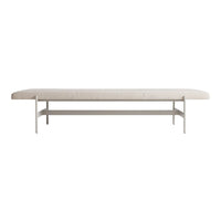 Light beige bench with a smooth surface and minimalist design, complemented by a sleek silver metal base.