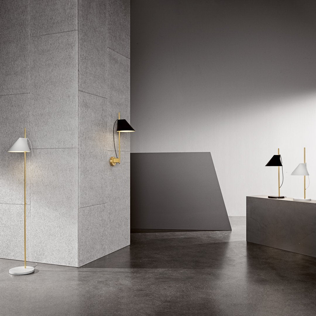 "Modern floor and wall lamps in black, white, and gold against a sleek gray backdrop."