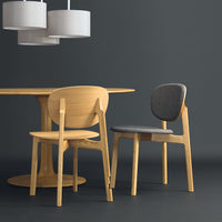Natural wood chairs with light and dark gray upholstery; modern, minimalist design against a dark backdrop.