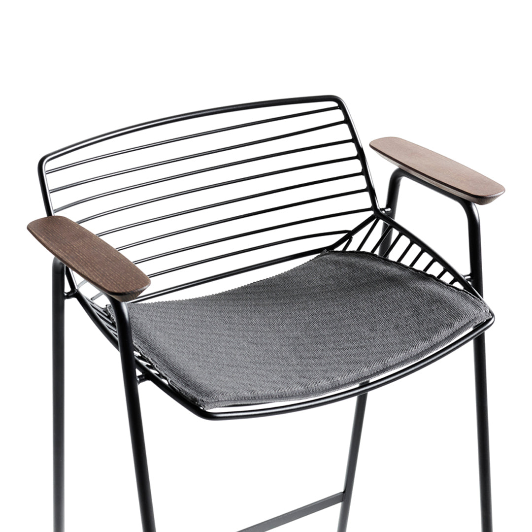 Black metal chair with horizontal stripes, featuring brown wooden armrests and a dark gray cushioned seat.