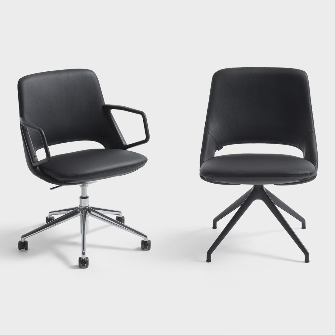 Black ergonomic chairs featuring clean lines and a modern design, with a sleek leather-like finish and contrasting bases.