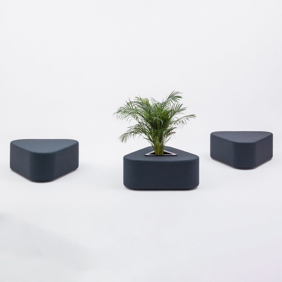 Dark blue geometric planters with smooth, modern shapes, featuring a central planter with greenery.