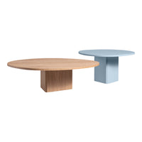 Light wood round coffee table and a pastel blue round table with a modern geometric base.