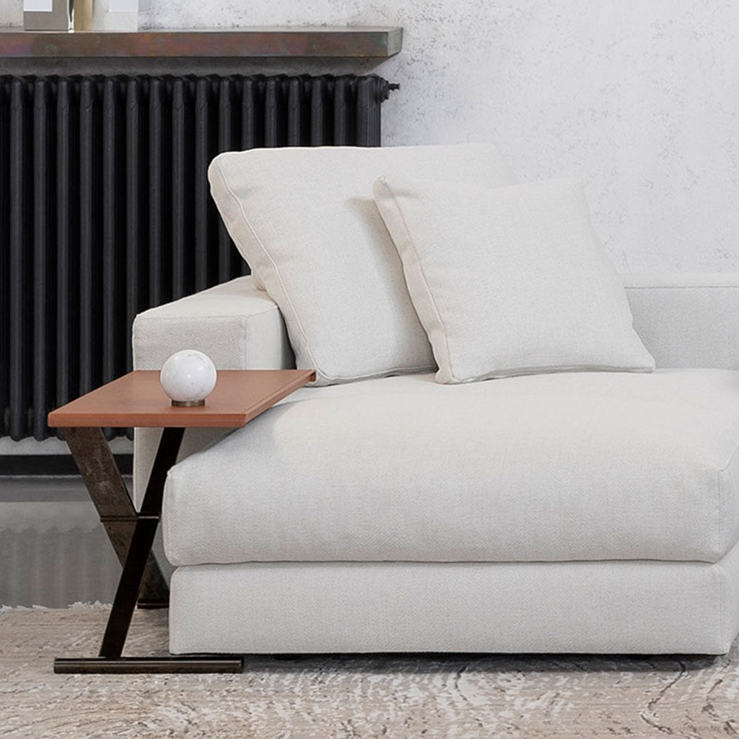 Cream sofa with solid wood side table, featuring a textured pattern and modern minimalist design against a neutral backdrop.