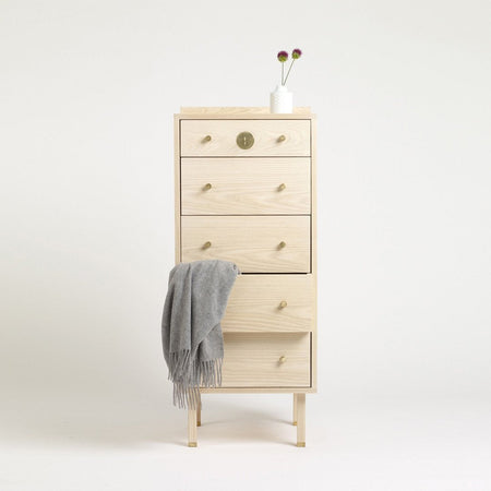 Light natural wood dresser with smooth, light grey accents and simple, stylish gold hardware.