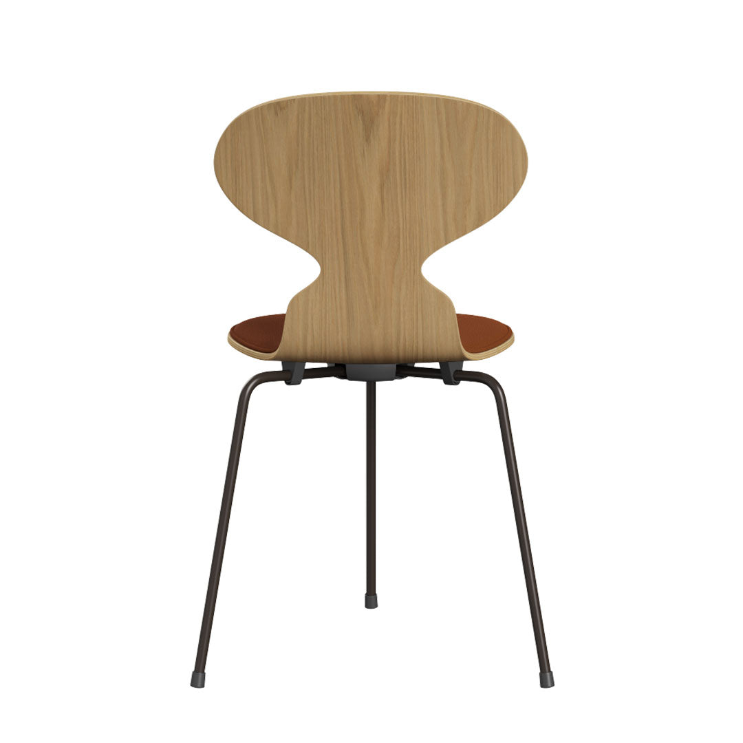 Light wood chair with a curved backrest and brown seat, featuring a sleek, modern design.