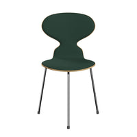 Green padded chair with a distinctive hourglass silhouette and natural wood accents, supported by sleek black legs.