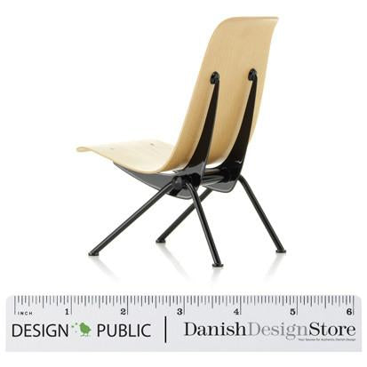 Modern chair featuring a sleek beige seat and contrasting black metal legs, showcasing minimalist design elements.