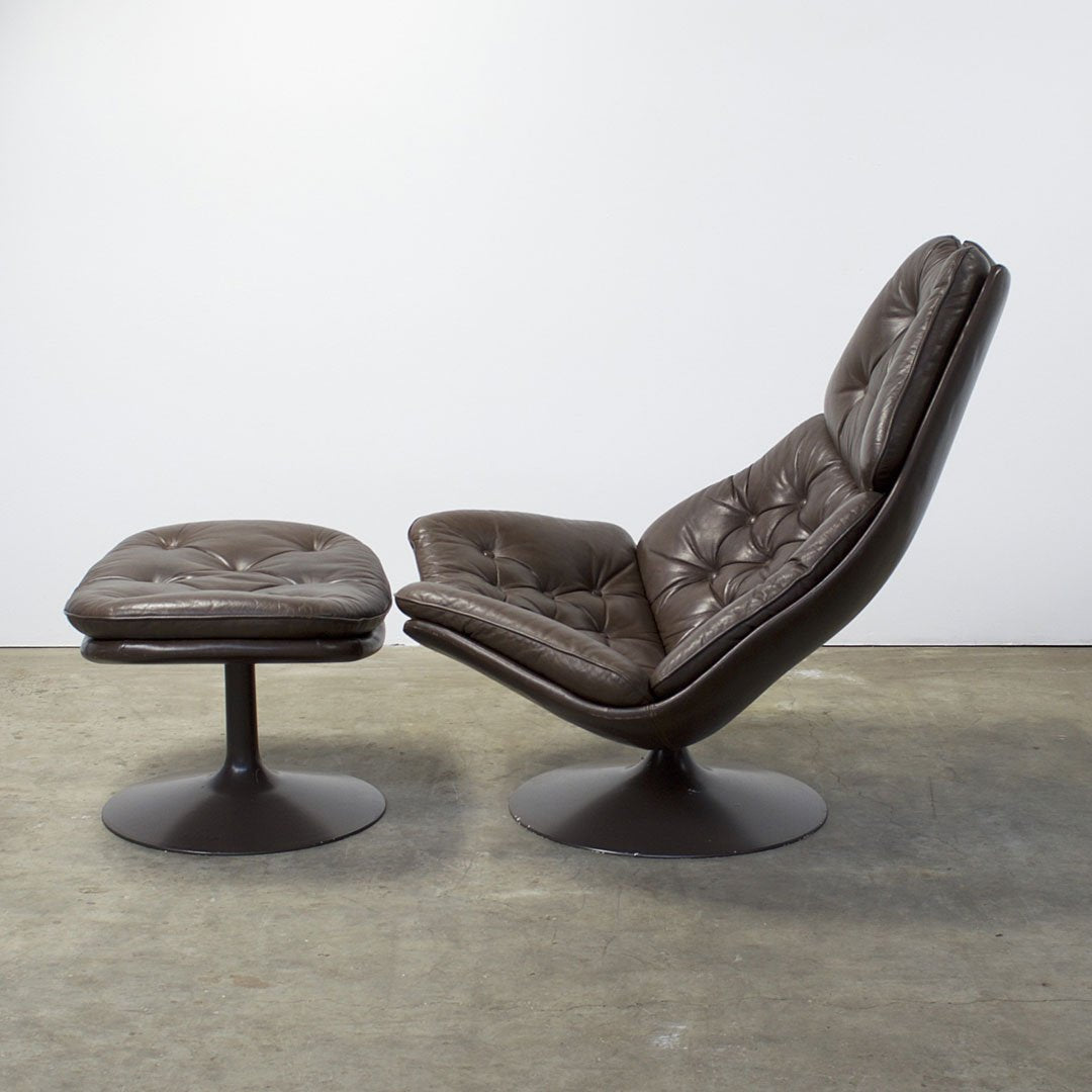 Brown leather lounge chair with tufted pattern and matching ottoman on a sleek black base.