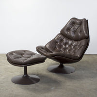 Brown leather armchair with tufted cushion design and matching ottoman, featuring a sleek, modern silhouette.