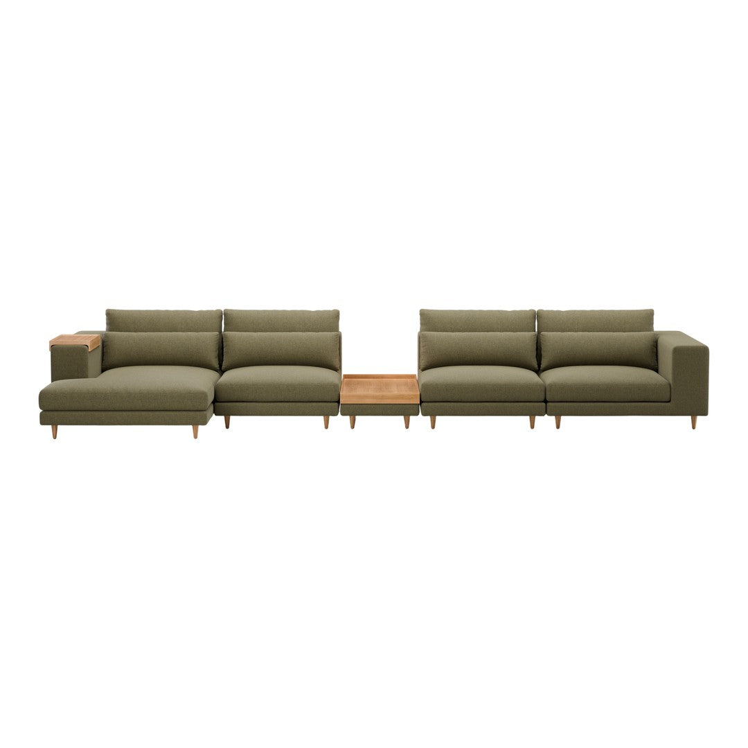 Olive green sectional sofa with clean lines and a light wood accent table in the center. Modern, minimalist design.