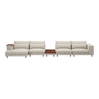 Light beige sectional sofa with plush cushions and a sleek wooden table accent. Modern, minimalist design.
