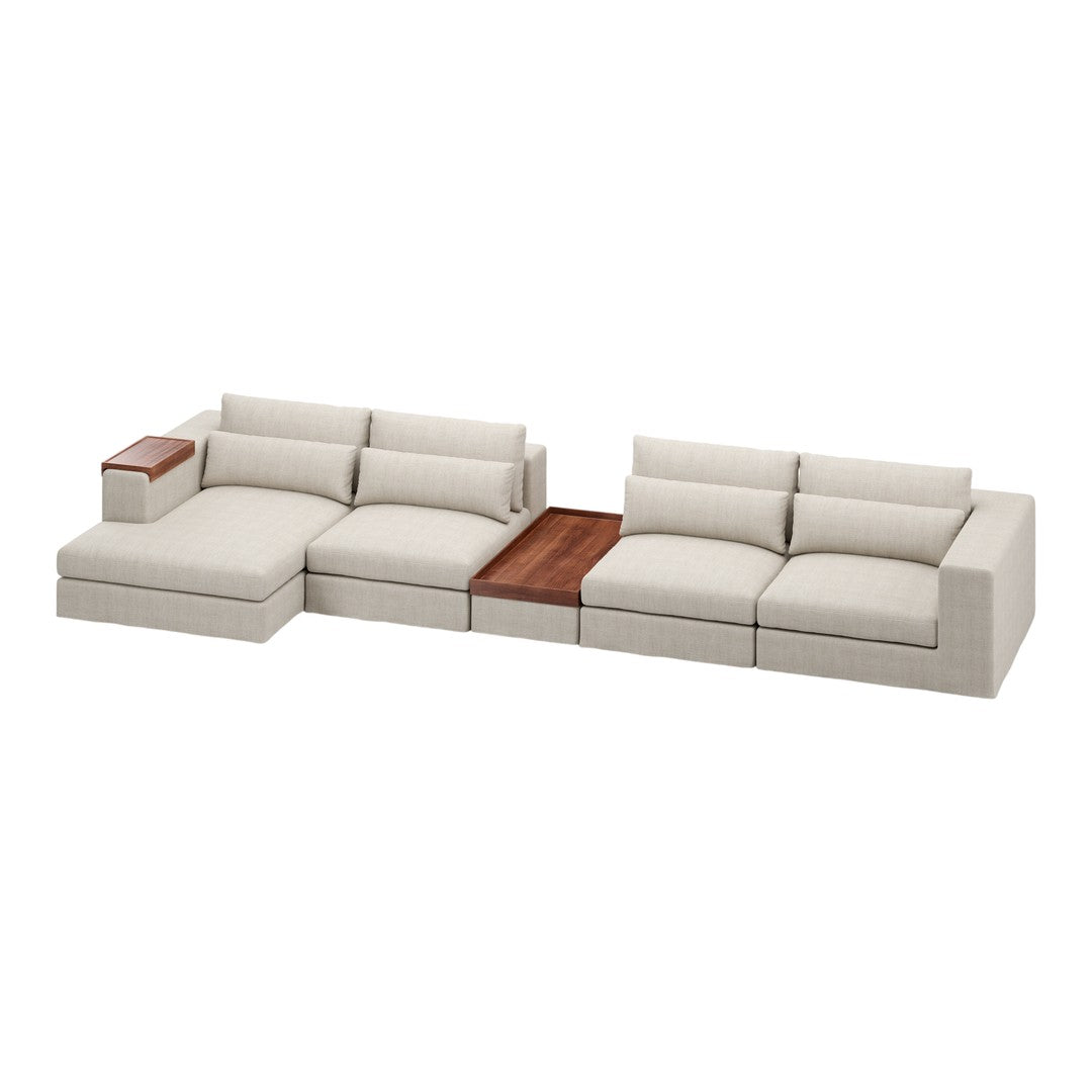 Beige sectional sofa with textured fabric and a wooden accent table, featuring clean lines and a modern design.