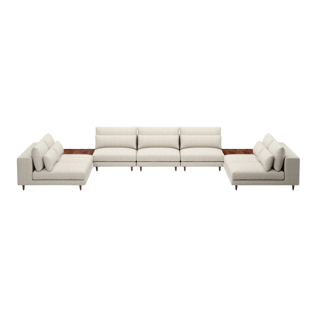 Cream-colored sectional sofa with smooth, clean lines and soft cushions. Elegant design complements modern décor.