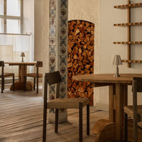 Warm wooden tones with natural textures, patterned tile column, and cozy decor create a rustic, inviting atmosphere.