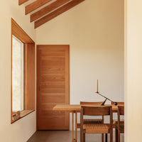 Light wood tones and clean lines create a warm, modern dining space with neutral walls and natural texture.