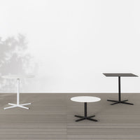 Modern minimalist tables featuring black and white colors with clean lines and simple geometric shapes.