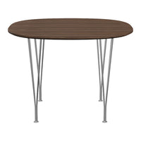 Round wooden dining table in rich brown with sleek silver metal legs. Minimalist design, perfect for modern decor.