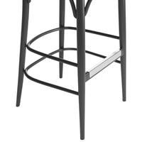 Black metal bar stool with sleek lines and a modern design, featuring chrome accents and minimalistic patterns.