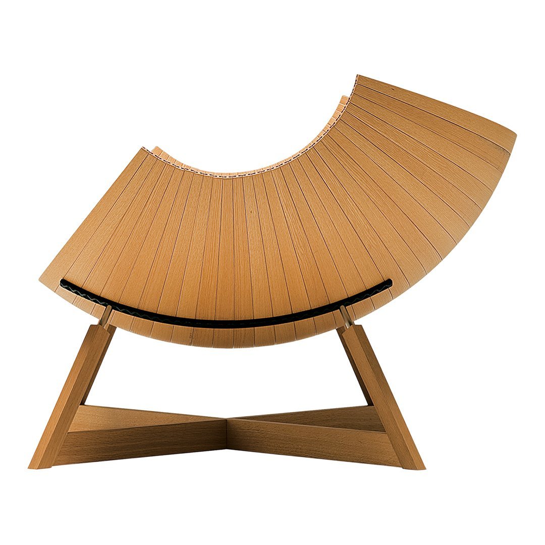 Curved wooden lounge chair in light natural wood finish with smooth, slatted pattern and dark accent band.