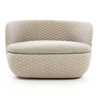 Beige upholstered chair with a quilted diamond pattern and smooth, rounded edges. Ideal for modern interiors.