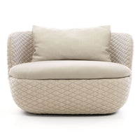 Beige upholstered sofa with diamond-patterned fabric and soft cushion pillows, exuding modern elegance.