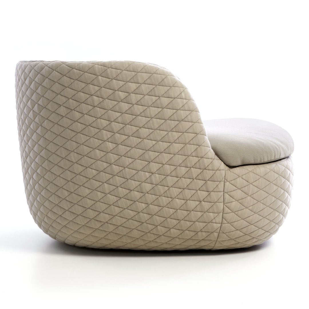 Beige upholstered chair with a diamond quilted pattern, offering a modern and stylish look.