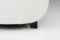 White textured fabric with sleek black legs, showcasing a modern and stylish design.
