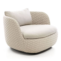 Beige quilted lounge chair with a smooth, rounded shape and a soft, cushioned seat and backrest. Perfect for cozy spaces.
