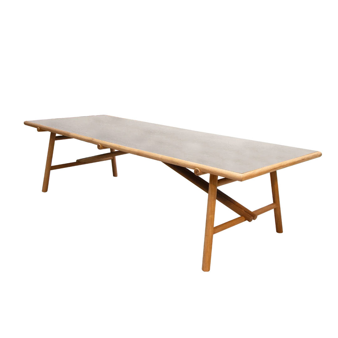 Modern wooden dining table with a smooth, light grey top and natural wood legs, featuring minimalist design.