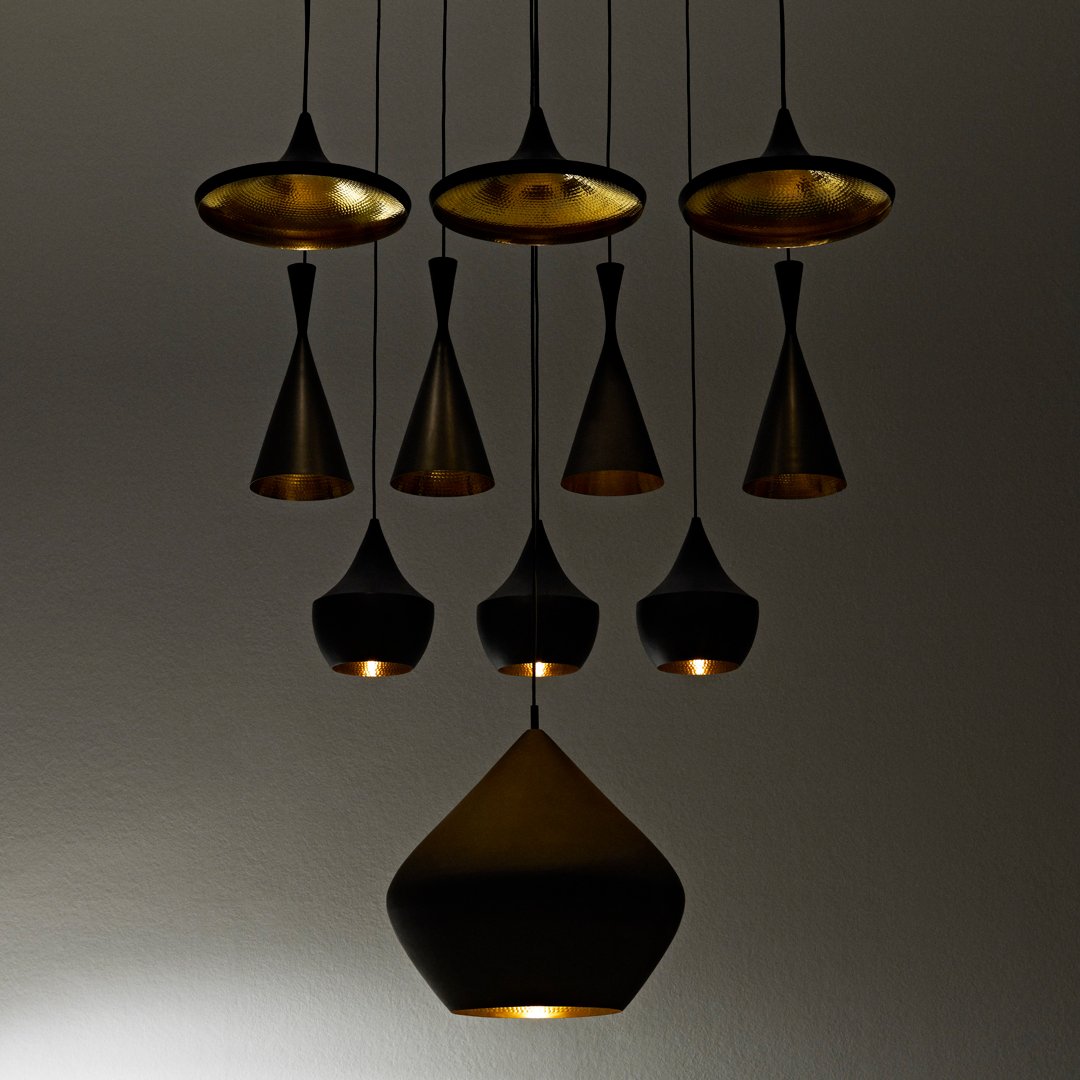 "Stylish black and gold pendant lights with various geometric shapes and textured patterns, perfect for modern decor."