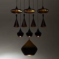 "Stylish black and gold pendant lights with various geometric shapes and textured patterns, perfect for modern decor."