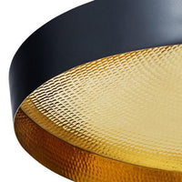 Black and gold pendant light featuring a textured, hammered gold pattern and sleek black rim for a modern aesthetic.