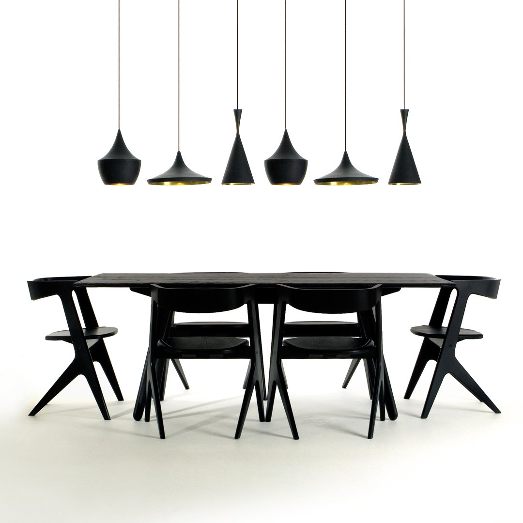 Sleek black dining table and chairs with modern black pendant lights, featuring minimalist shapes and an elegant design.