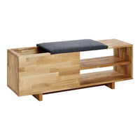 "Natural wood finish with a light grain pattern and a dark gray cushioned top."