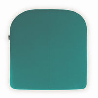 Teal square cushion with a smooth, solid texture and rounded edges, ideal for home decor.