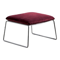 Burgundy velvet ottoman with sleek chrome legs, perfect for modern decor.