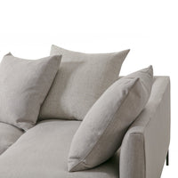 Light gray sofa with textured pillows, featuring subtle fabric patterns for a modern, minimalist look.