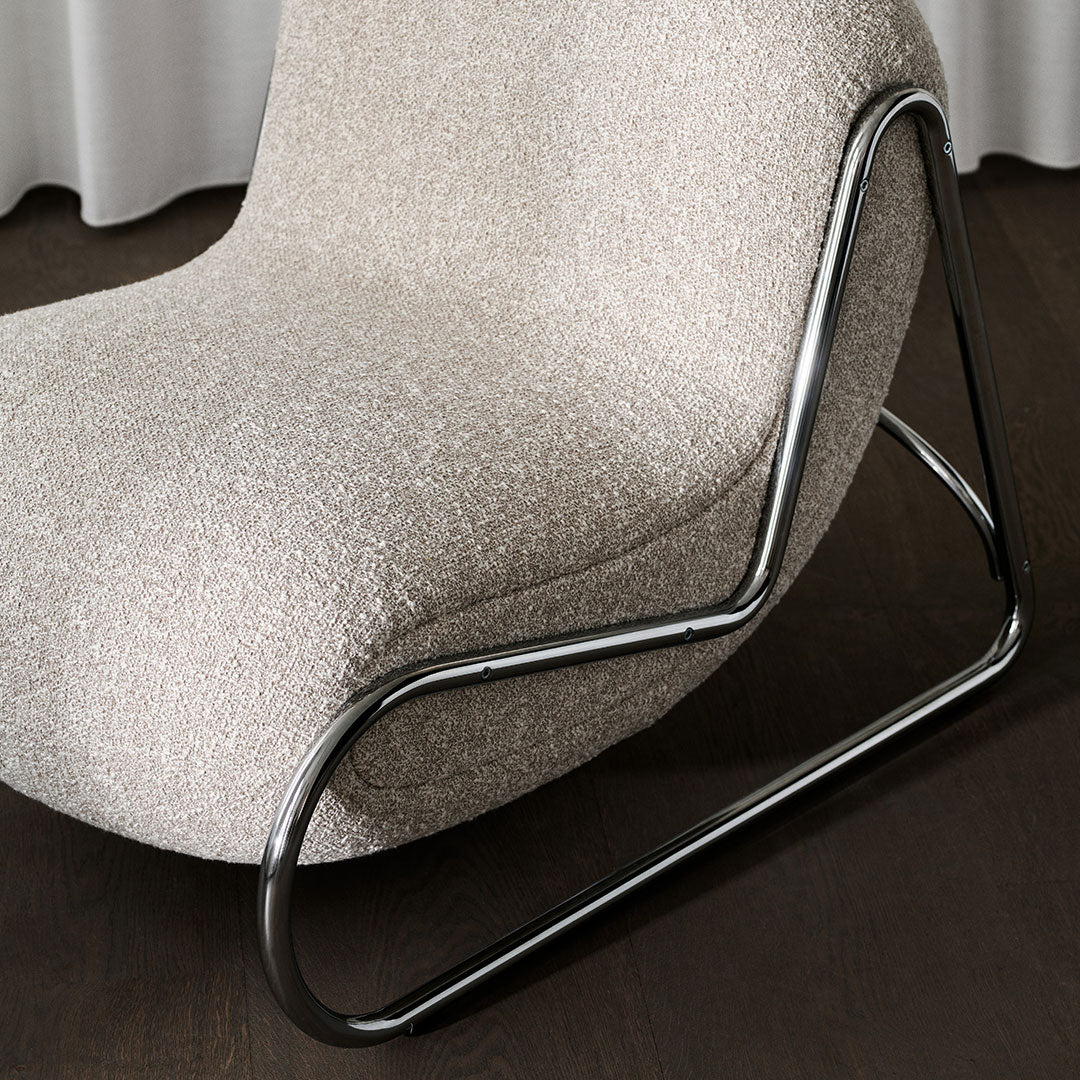 Beige textured chair with sleek black metal base, showcasing a modern and minimalist design. Perfect for contemporary decor.