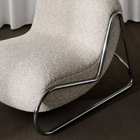 Beige textured chair with sleek black metal base, showcasing a modern and minimalist design. Perfect for contemporary decor.
