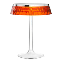 Stylish transparent table lamp with a textured orange shade and chrome accents, perfect for modern decor.