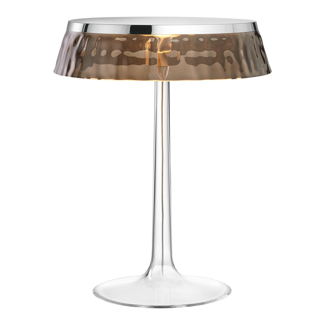 Stylish clear acrylic lamp with a hammered bronze shade, combining modern elegance and sophisticated patterns.