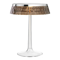 Stylish clear acrylic lamp with a hammered bronze shade, combining modern elegance and sophisticated patterns.