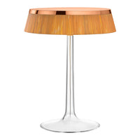 Stylish lamp with a clear base and a textured golden-orange shade set against a sleek design. Perfect for modern decor.