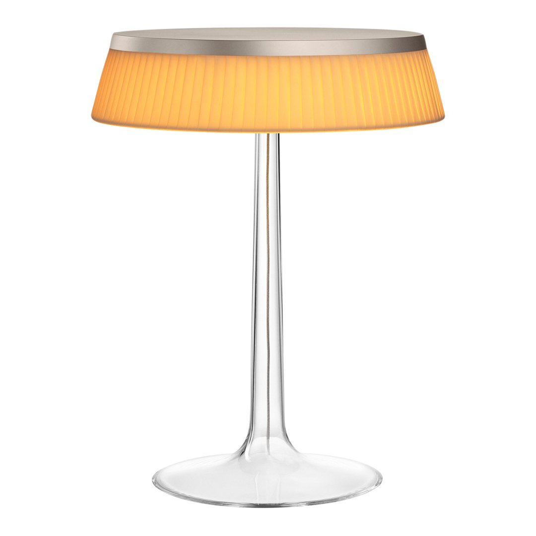 Modern lamp with a clear base and vibrant orange pleated shade, featuring a sleek silver top. Perfect for stylish decor.