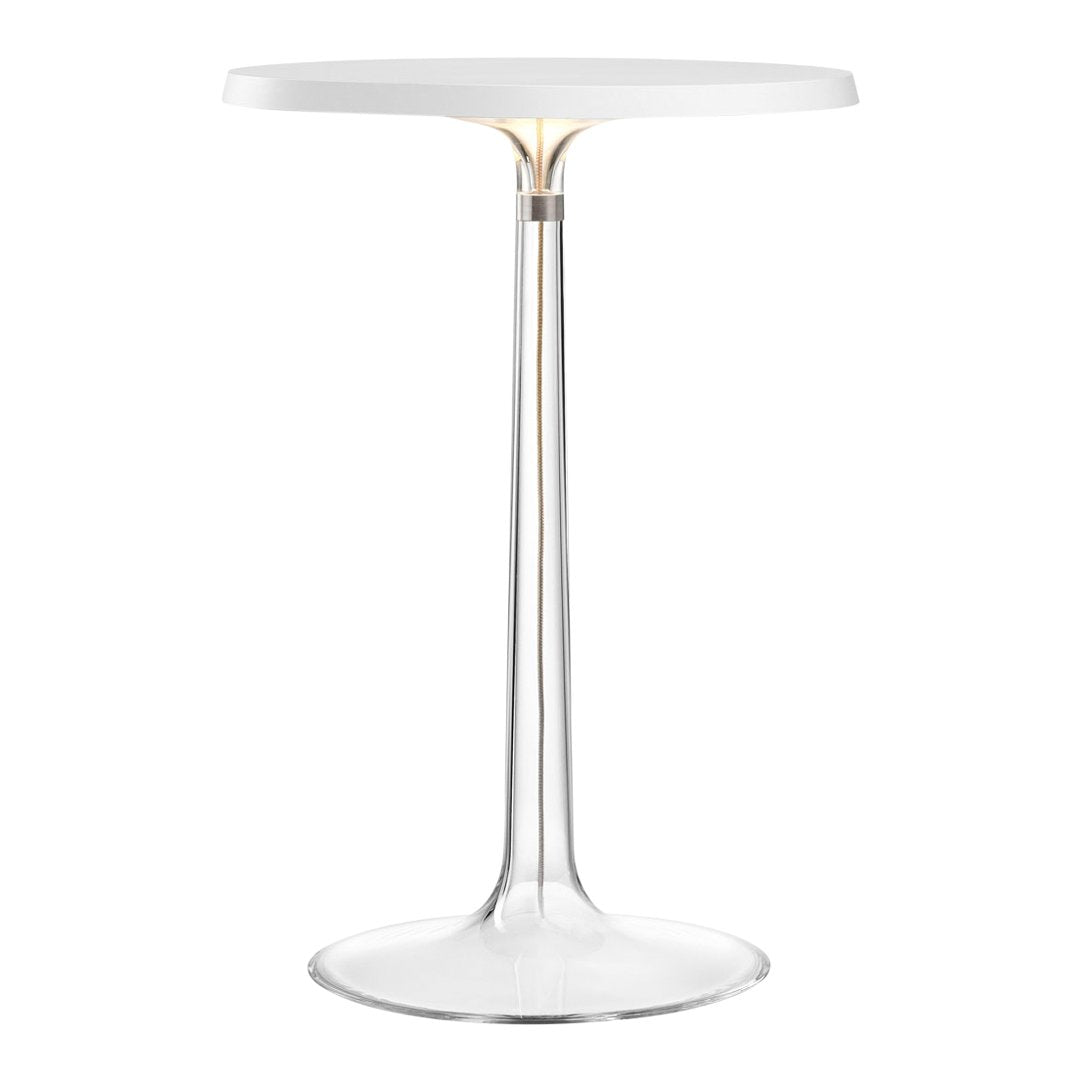 Sleek modern white round table with clear plastic base and subtle gold detailing, perfect for stylish interiors.